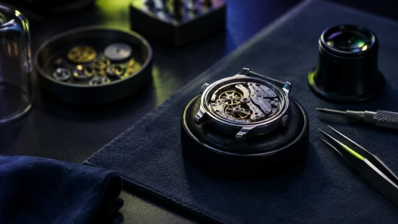 Watchmaker bench with an open watch movement and tools, for choosing an ecommerce PPC agency